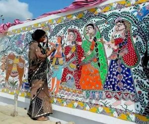 women painting a wall with Madhubani painting in Patna